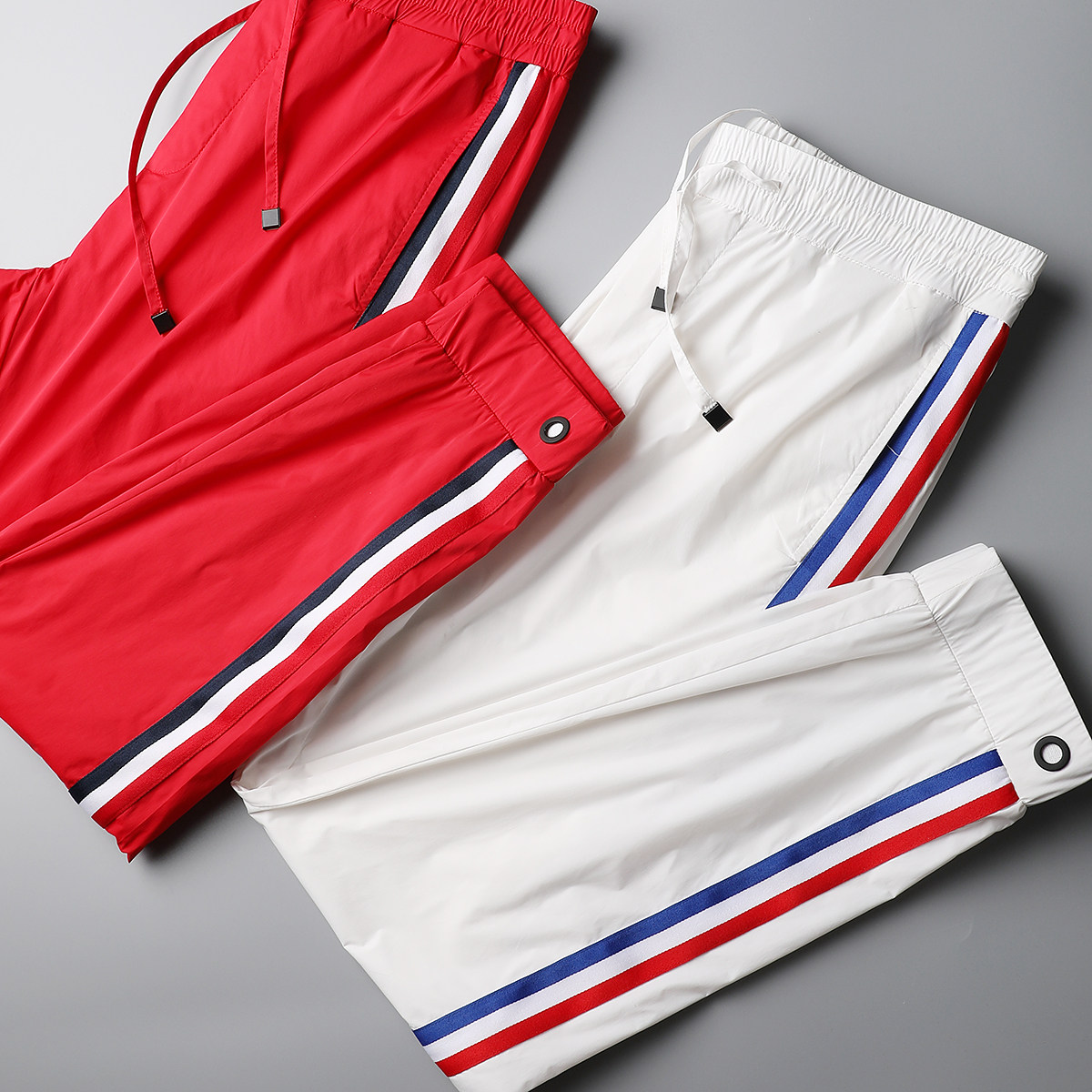 Trendy men are crazy about the new summer men's trousers. They are red, black and white contrasting striped thin men's casual pants and sport sweatpants for men