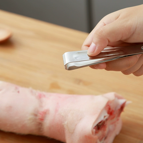 Кухонные предметы прикладывают инструменты из нержавеющей стали для свиньи.