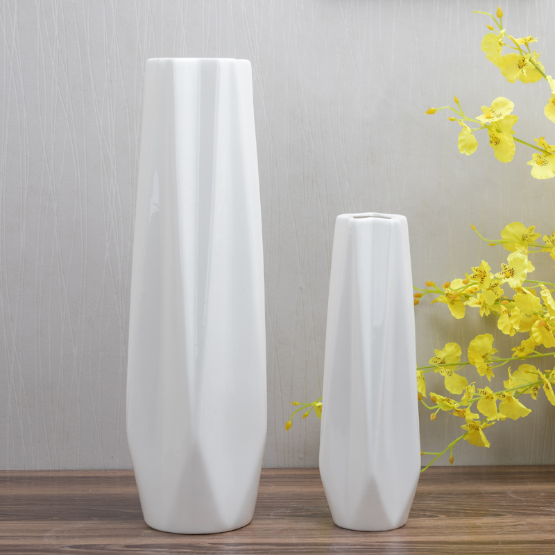 Three ceramic vases in different colors: grey, white, black