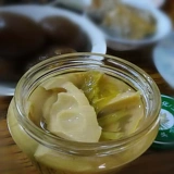 Подлинные соленые огурцы на гриле бамбук стреляет новые вкусные соленые огурцы и бутылки с бамбуком с помощью рисового банкетного бассейна.